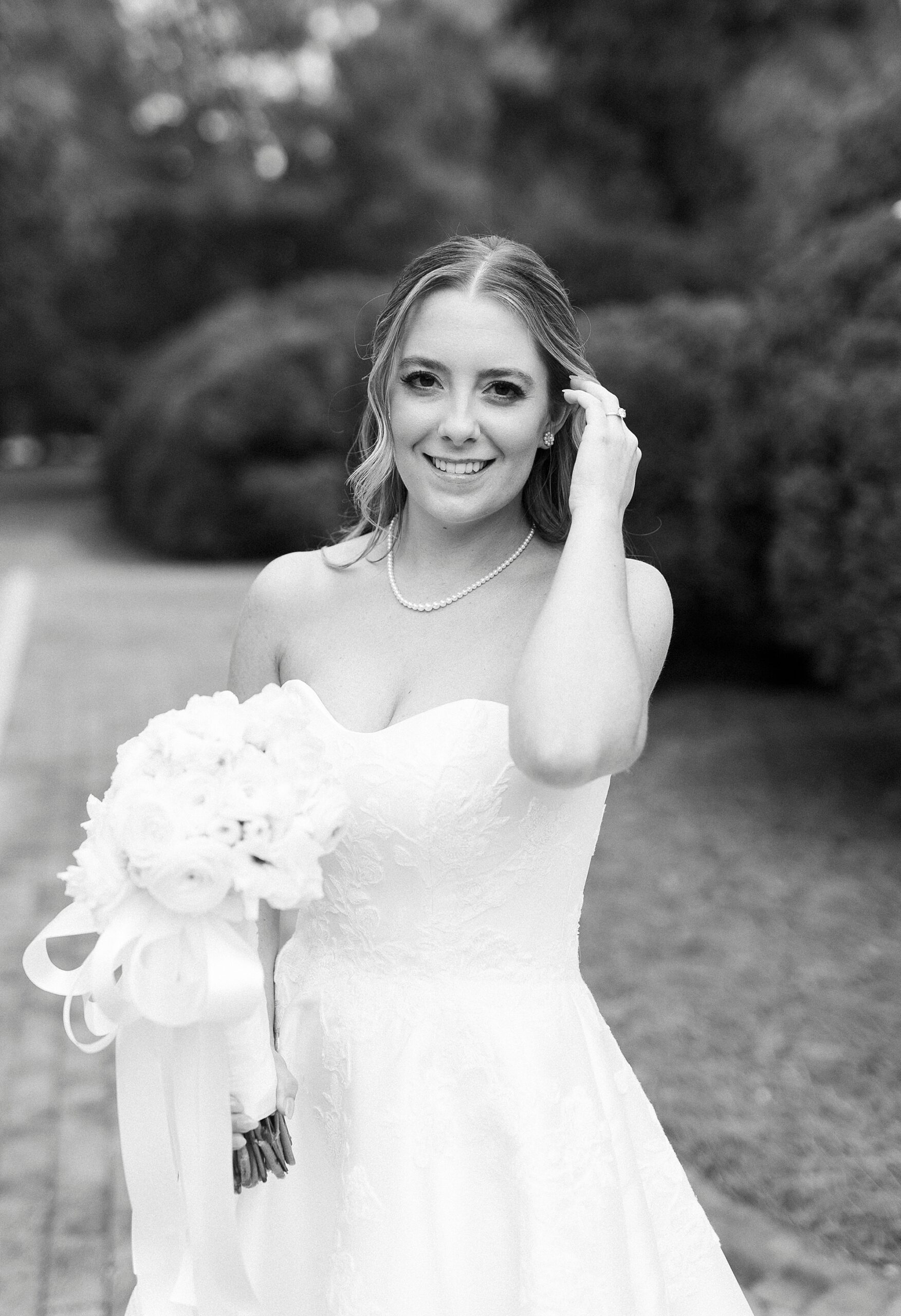 bride pushes hair behind her ear during bridal portraits at the Sutherland