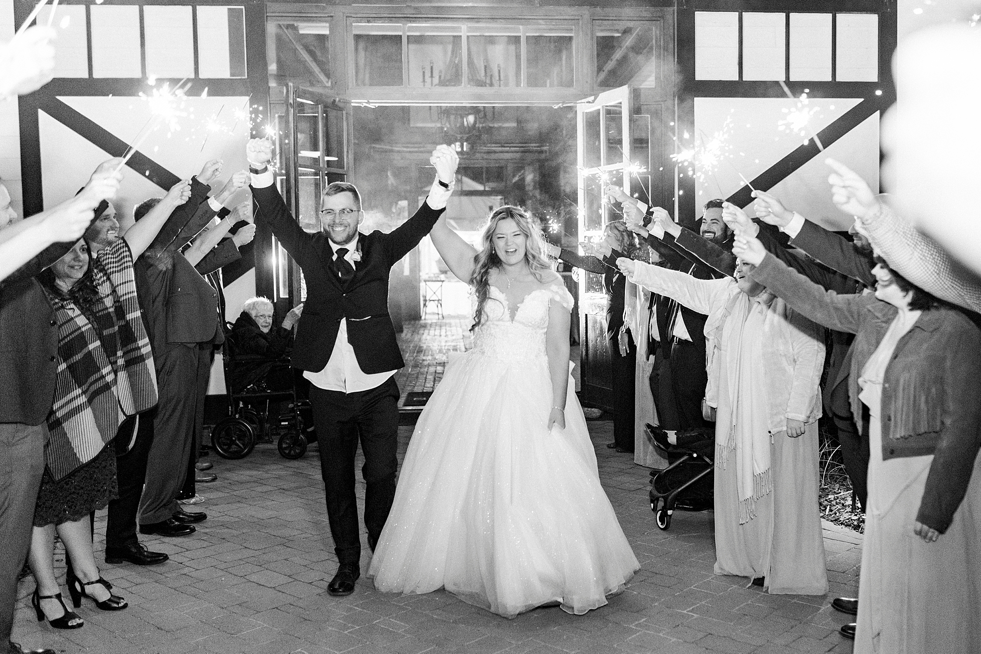bride and groom cheer leaving Summerfield Farms in sparkler exit