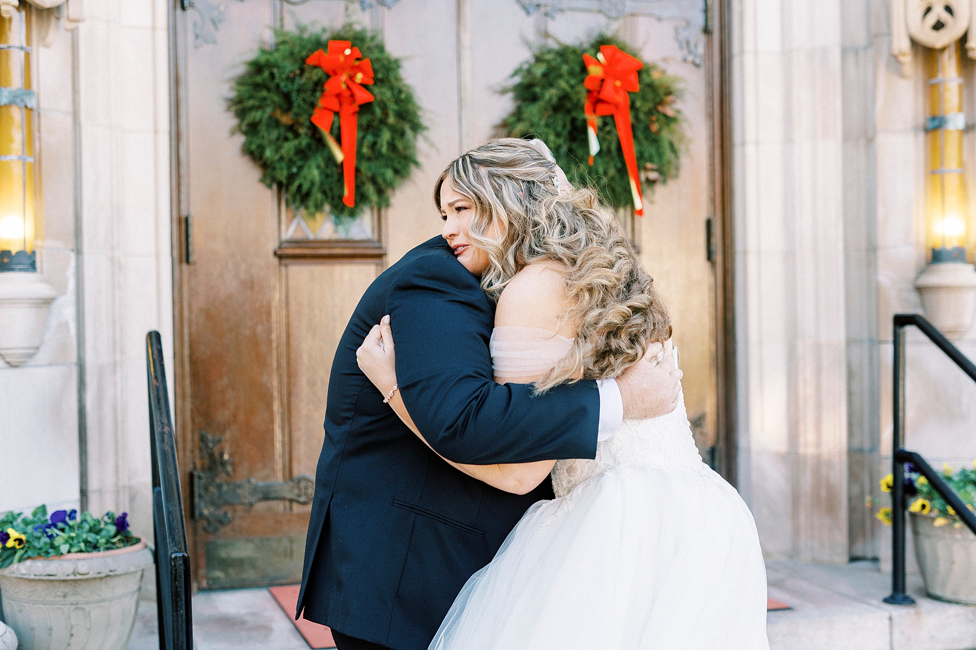 bride and dad hug during first look outside Our Lady of Grace