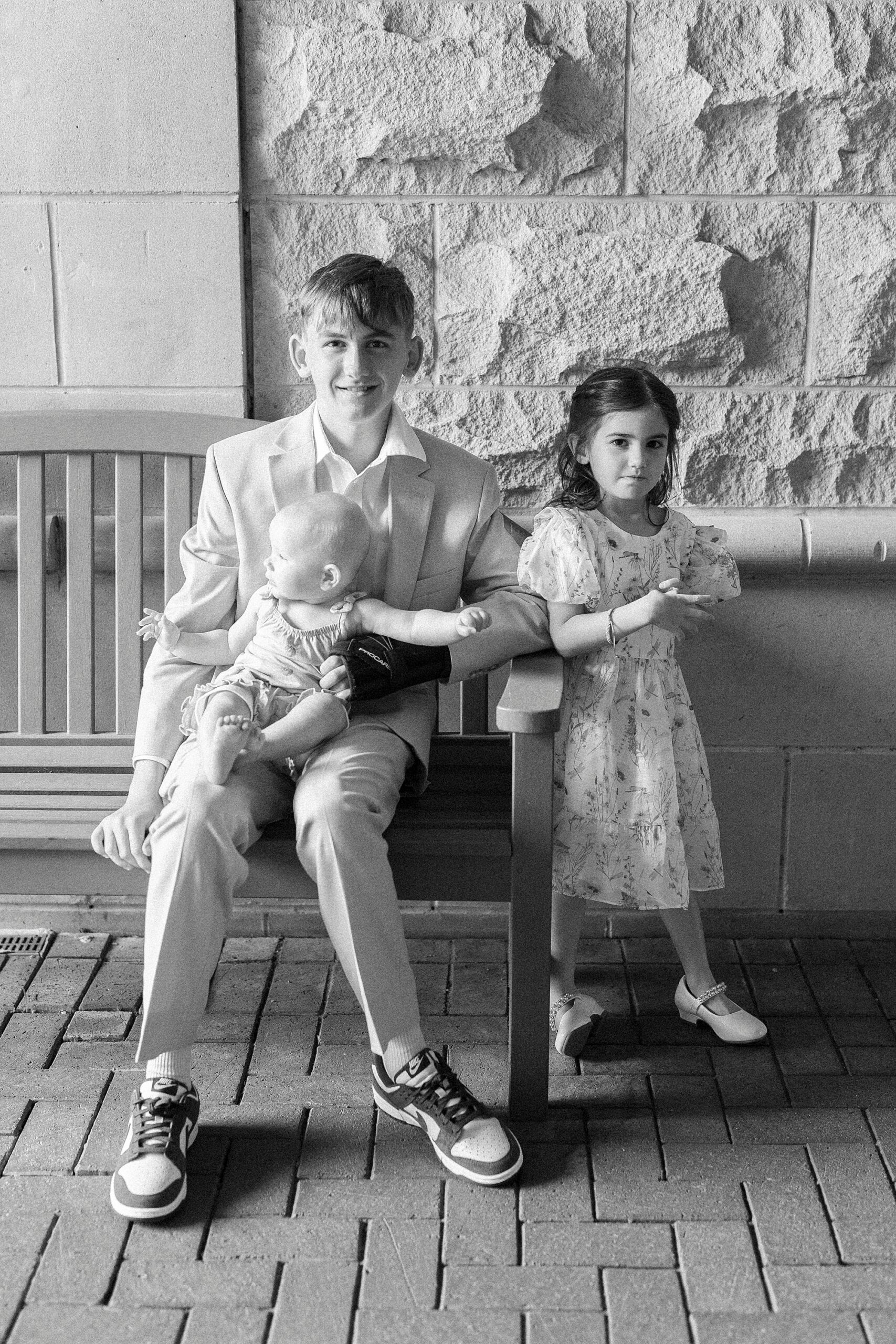 kids sit outside St. Mary's Chapel before wedding ceremony