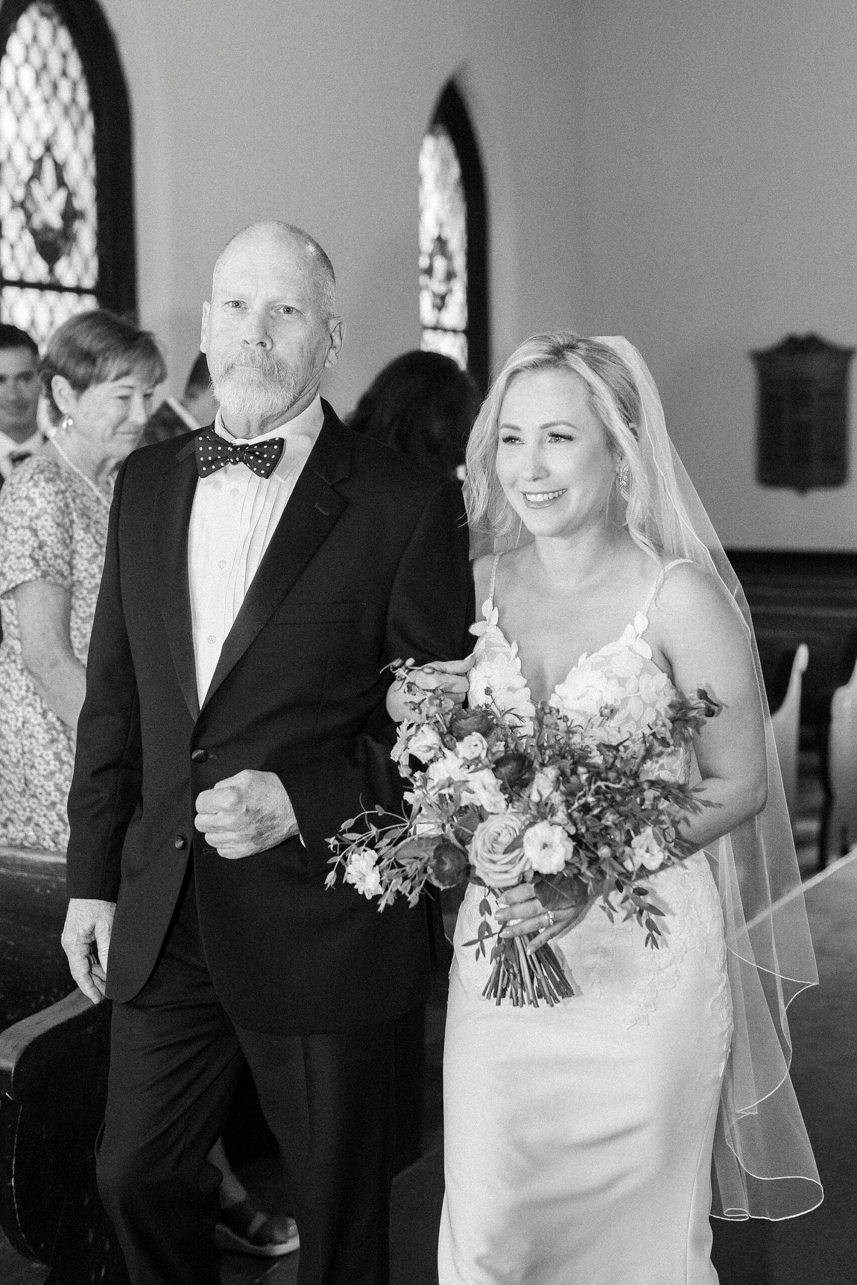 man escorts bride down aisle in St. Mary's Chapel