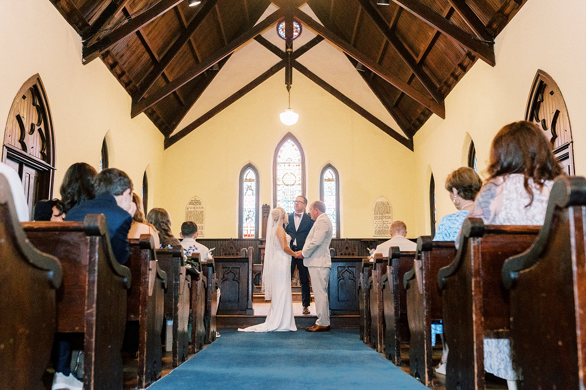 bride and groom stand at alter inside St. Mary's Chapel
