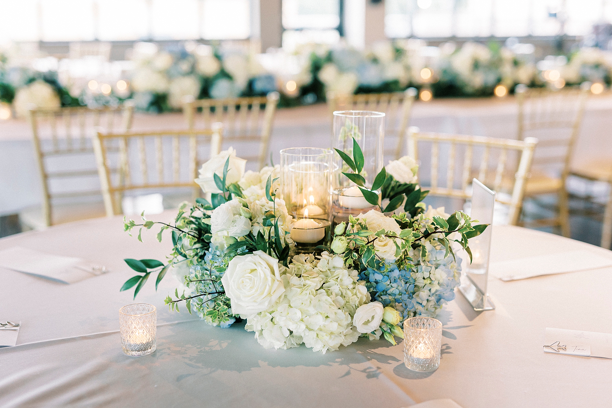 white and blue floral centerpieces for reception at Terrace at Cedar Hill