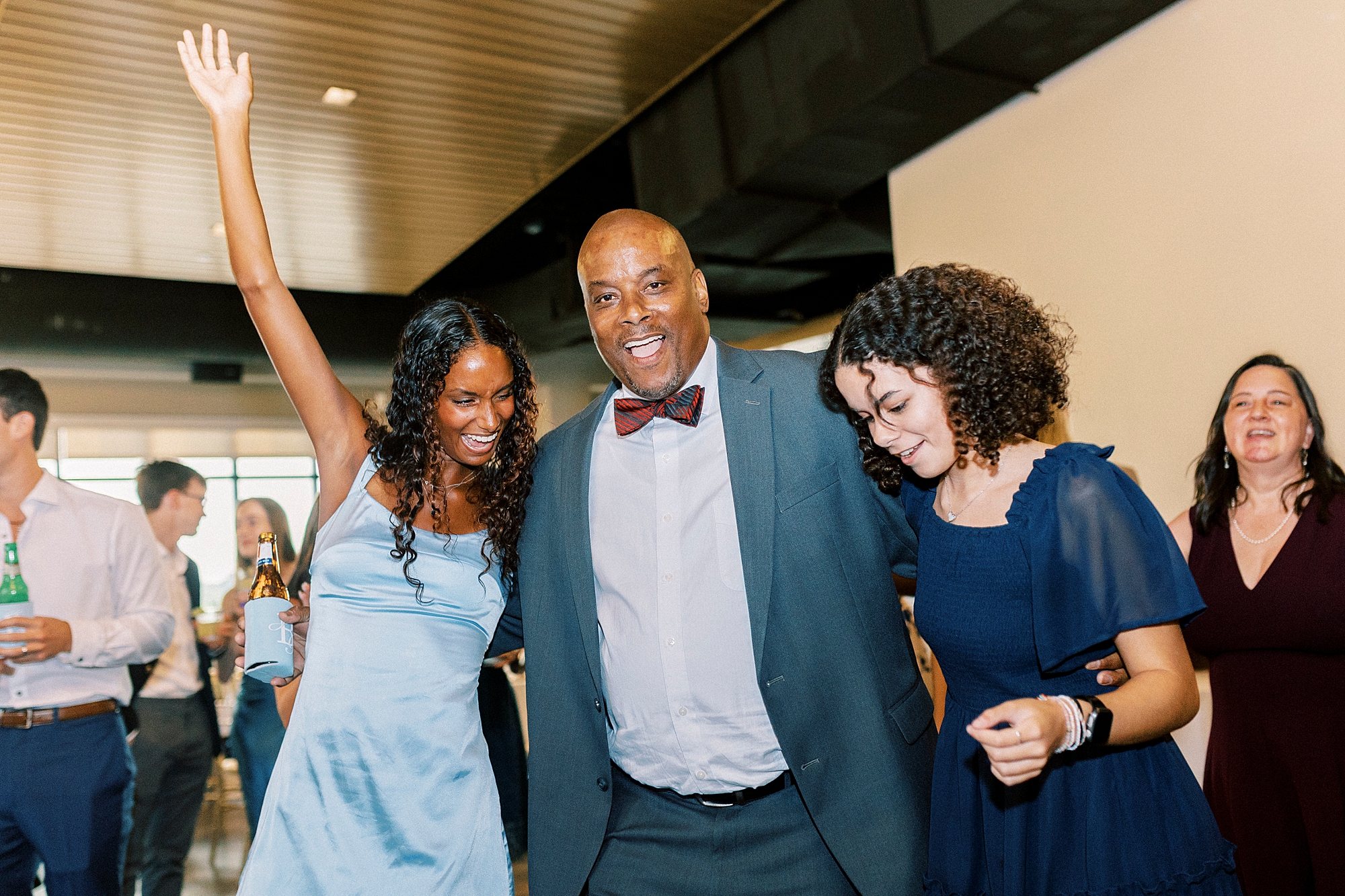 wedding guests pose together on dance floor during reception at Terrace at Cedar Hill