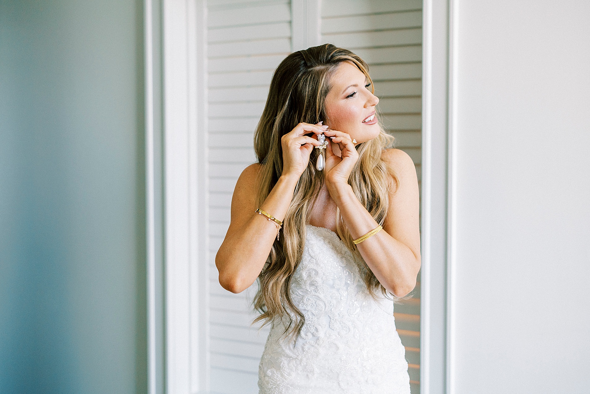 bride putting in earrings 